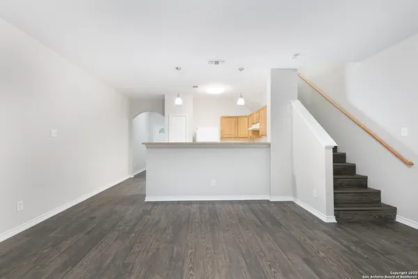 a view of a kitchen with wooden floor and stairs