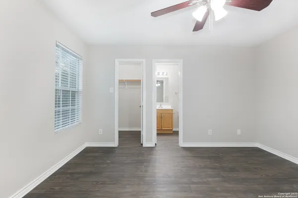 a view of an empty room with wooden floor