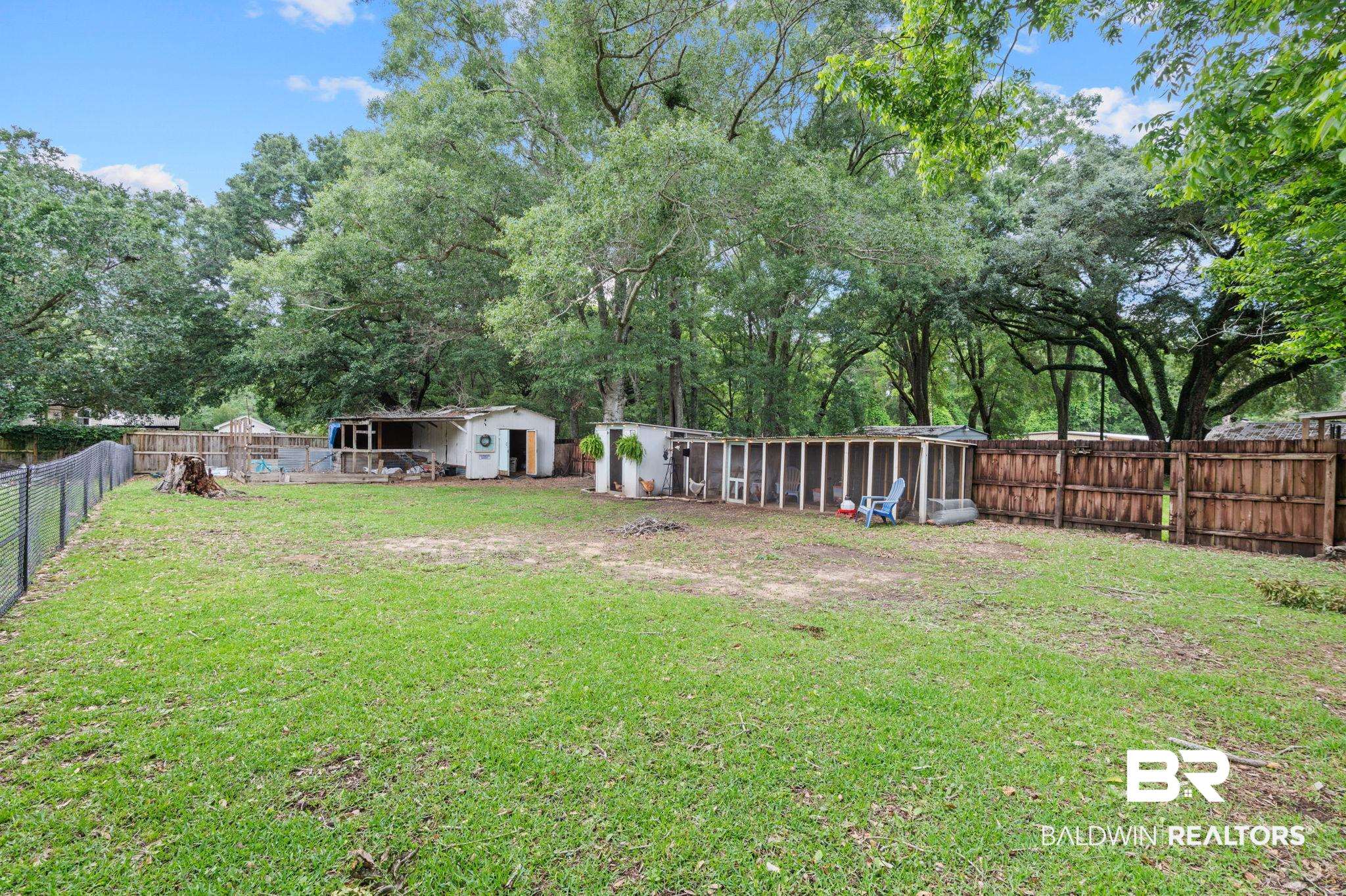 5936 Lundy Road Theodore, AL 36582 - Photo 31 of 32 Expansive backyard featuring a partial chain link fence and a partial wood privacy fence