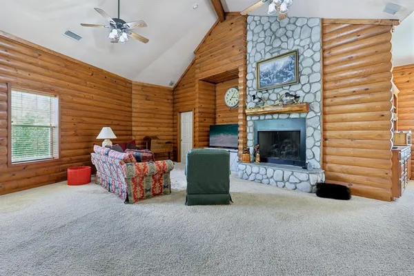 a view of a dining room with furniture and a chandelier