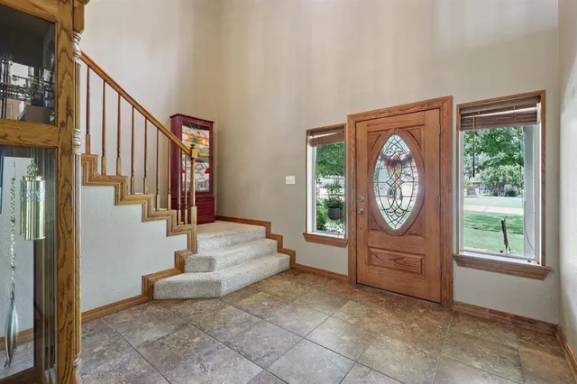 a view of a hallway with window and furniture