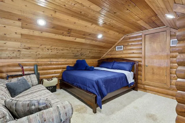 a front view of a building with garden and outdoor seating