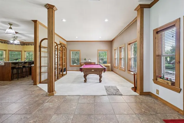 a living room with furniture and large windows