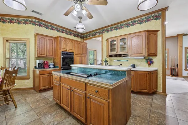 a kitchen with stainless steel appliances granite countertop a stove and cabinets
