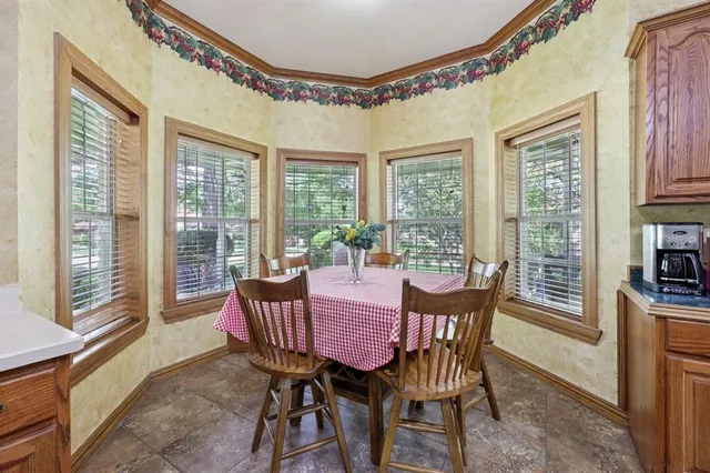 a view of a dining room with furniture large windows and wooden floor