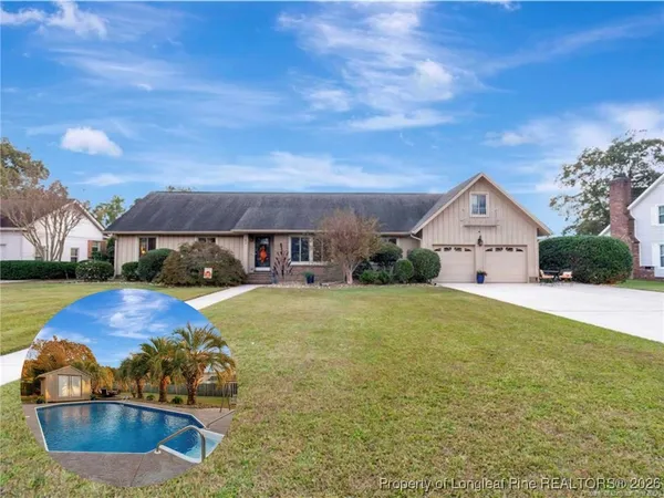 a view of a house with a yard and tree