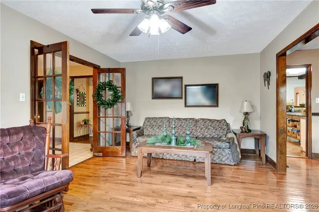 a very nice looking living room with dining room and wooden floor