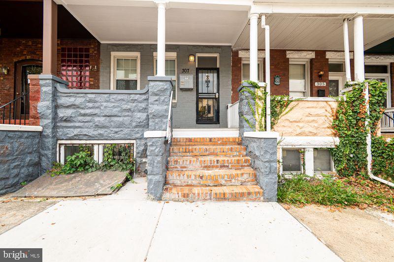 307 East 25th Street, Unit BASEMENT APARTMENT Baltimore, MD 21218 - Photo 3 of 21 a front view of a house with garden