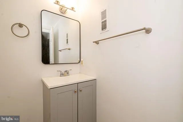 a bathroom with a toilet sink and a mirror