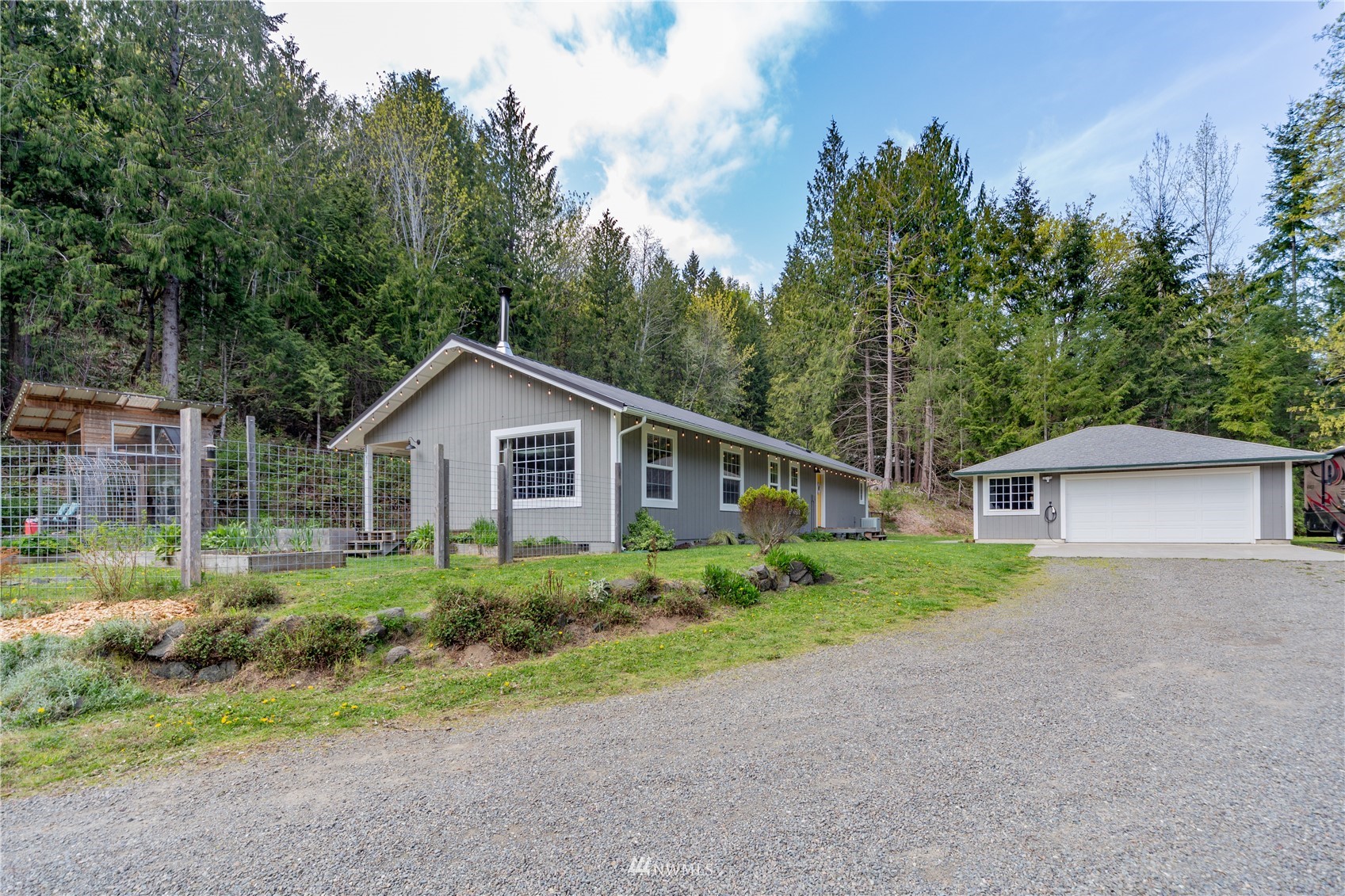 2310 West Valley Road Chimacum, WA 98325 - Photo 1 of 40 a house with trees in the background