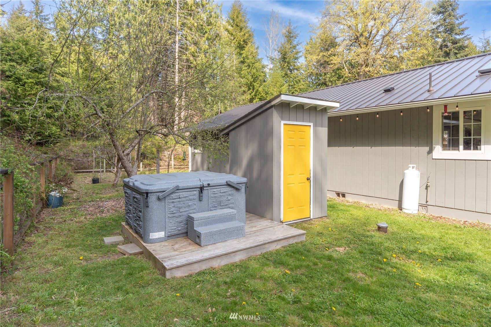 2310 West Valley Road Chimacum, WA 98325 - Photo 17 of 40 a view of a tiny house with a big yard and large tree