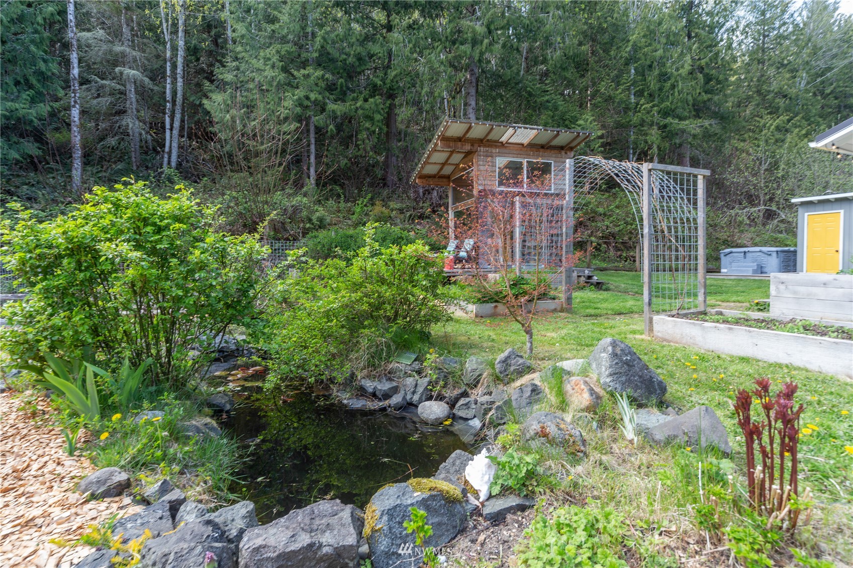 2310 West Valley Road Chimacum, WA 98325 - Photo 18 of 40 a view of a house with a yard and garden