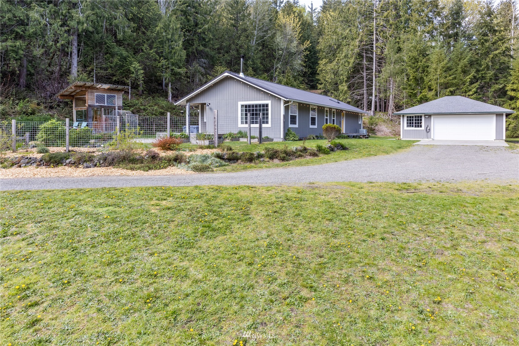 2310 West Valley Road Chimacum, WA 98325 - Photo 2 of 40 a front view of a house with a yard and garage