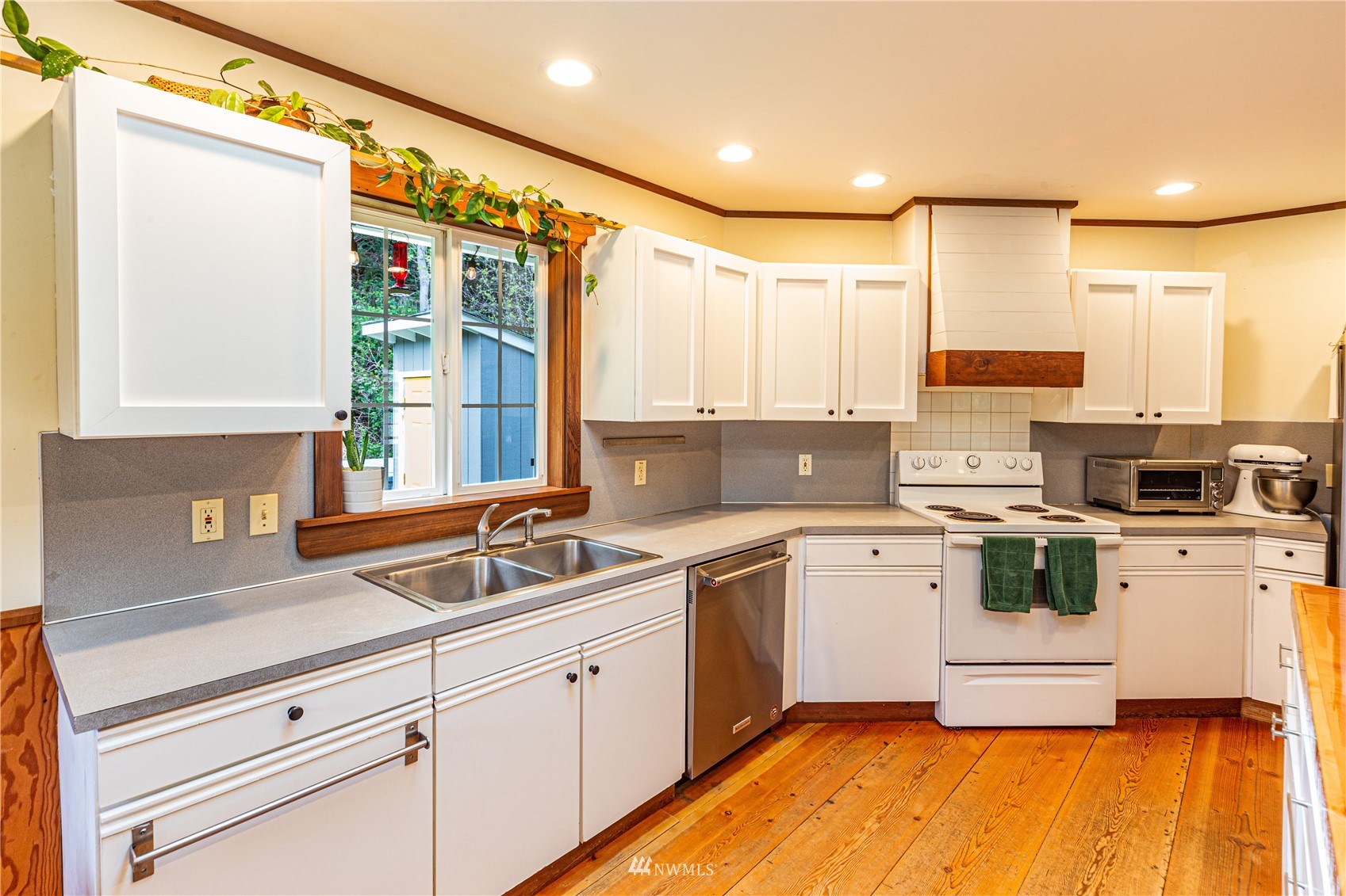 2310 West Valley Road Chimacum, WA 98325 - Photo 27 of 40 a kitchen with a sink cabinets stainless steel appliances and a window