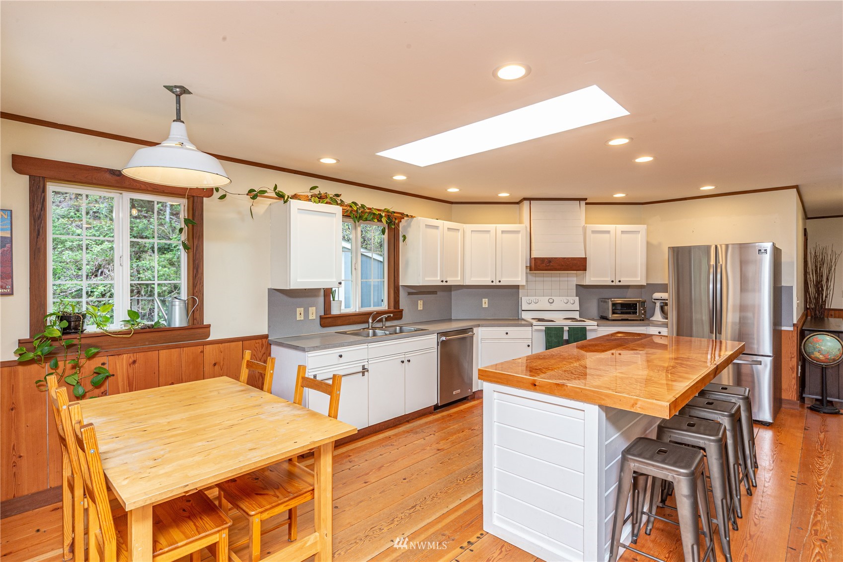 2310 West Valley Road Chimacum, WA 98325 - Photo 29 of 40 a kitchen with stainless steel appliances granite countertop a stove top oven a sink dishwasher and a refrigerator with wooden floor