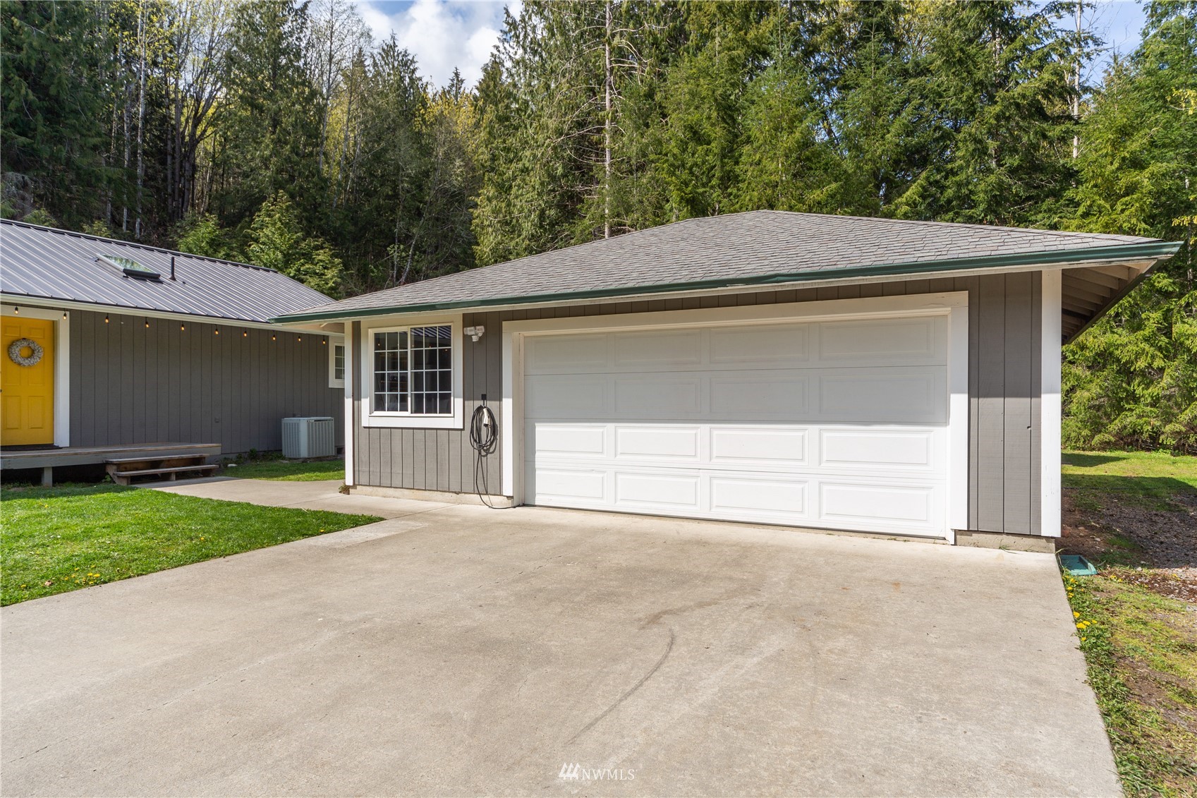 2310 West Valley Road Chimacum, WA 98325 - Photo 3 of 40 a front view of a house with a yard and garage