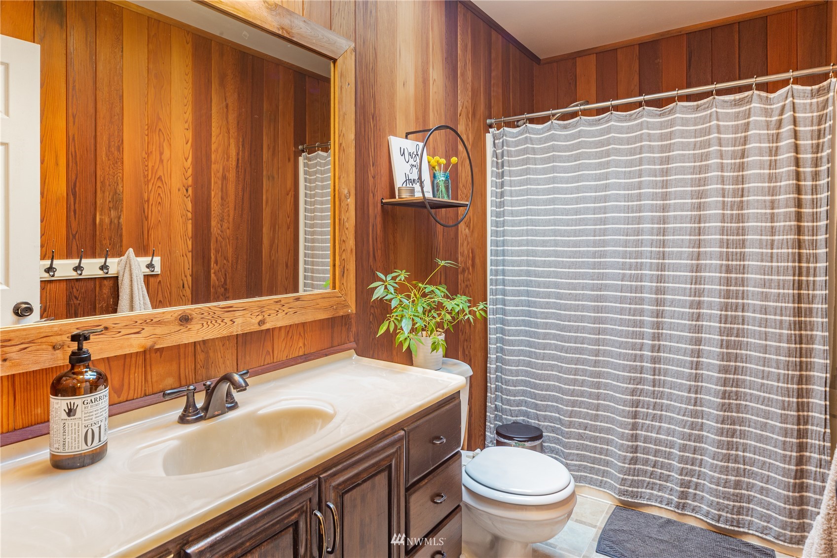 2310 West Valley Road Chimacum, WA 98325 - Photo 40 of 40 a bathroom with a granite countertop toilet a sink and a mirror