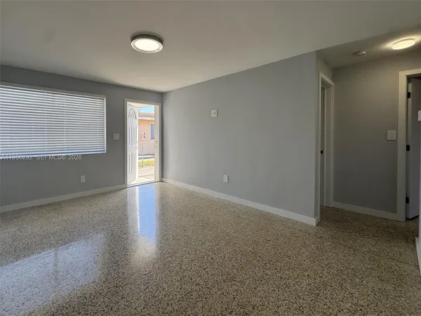 an empty room with windows and closet