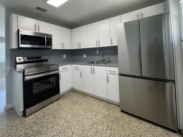 a kitchen with a refrigerator sink and microwave
