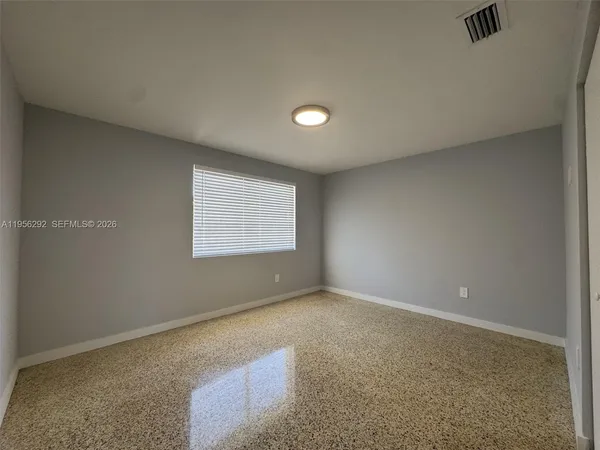 a view of an empty room with a window