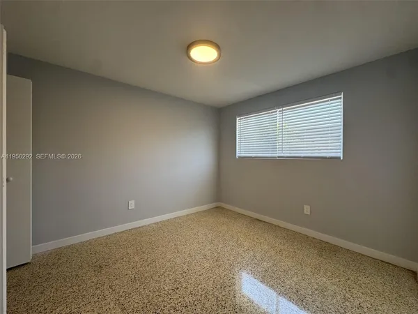 an empty room with window and space