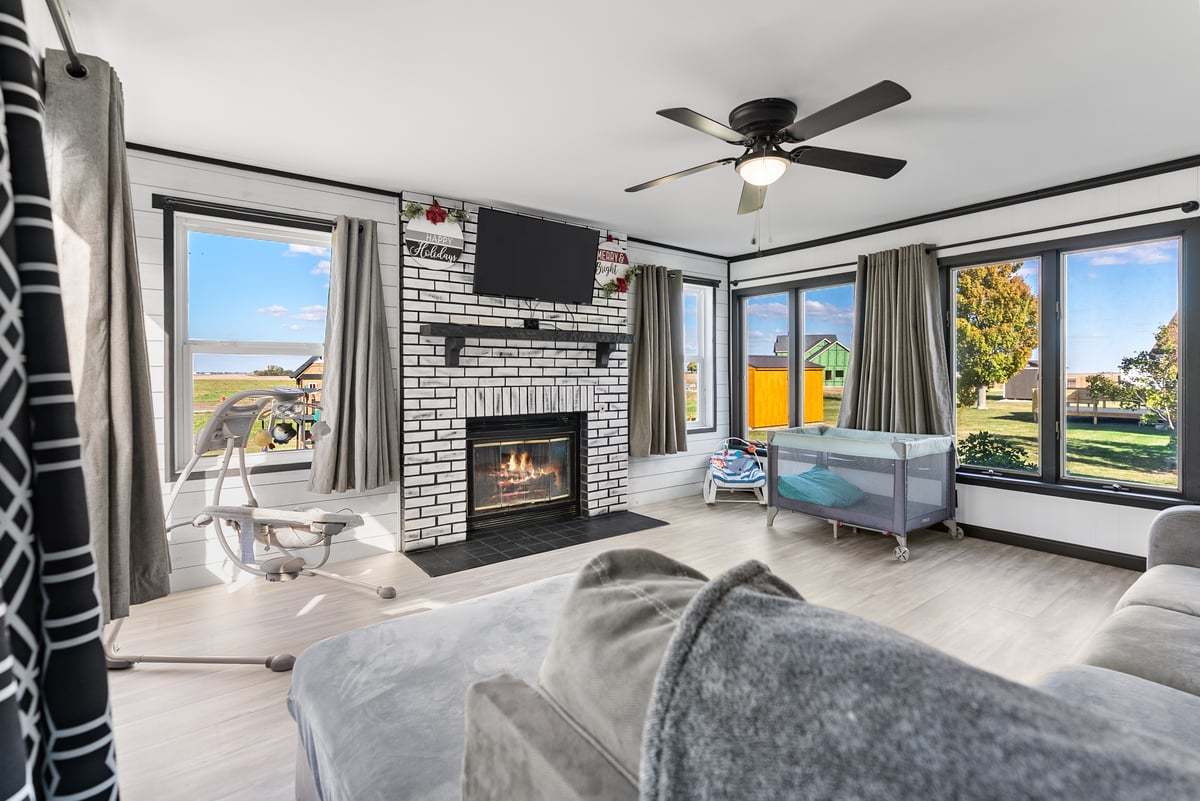 208 East 8th Street Gridley, IL 61744 - Photo 11 of 20 a living room with furniture fireplace and a large window