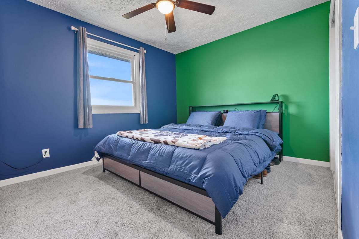 208 East 8th Street Gridley, IL 61744 - Photo 14 of 20 a bedroom with a bed and a chandelier