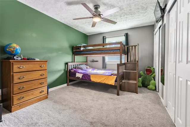 a bedroom with furniture and a ceiling fan