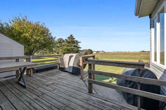 a view of a roof deck with wooden floor and fence