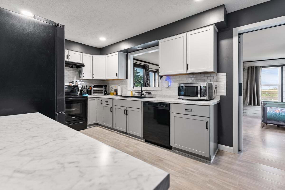 208 East 8th Street Gridley, IL 61744 - Photo 6 of 20 a kitchen with stainless steel appliances granite countertop a stove sink and cabinets