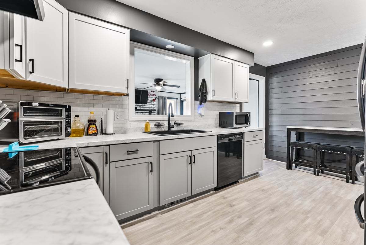 208 East 8th Street Gridley, IL 61744 - Photo 9 of 20 a kitchen with stainless steel appliances kitchen island granite countertop a stove top oven a sink and white cabinets