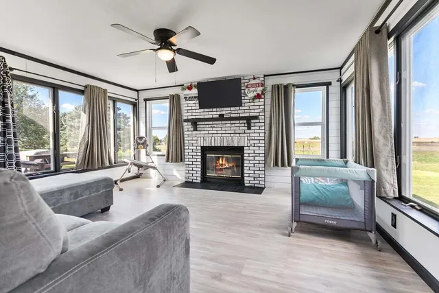 a living room with furniture fireplace and window