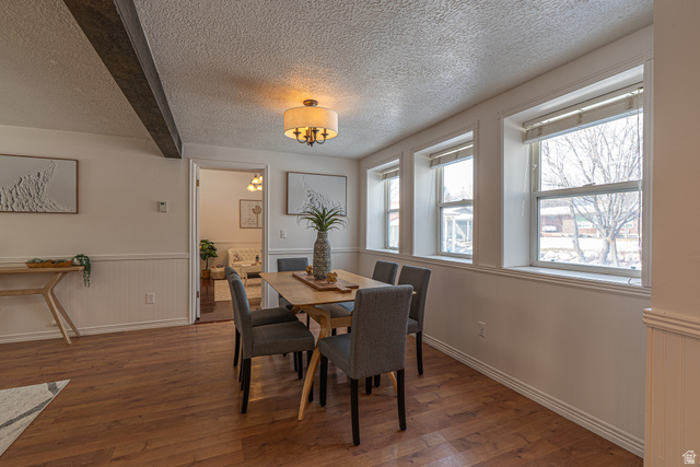 1045 Fox Farm Road Logan, UT 84321 - Photo 24 of 65 Dining area featuring hardwood / wood-style flooring, wainscoting, and a textured ceiling