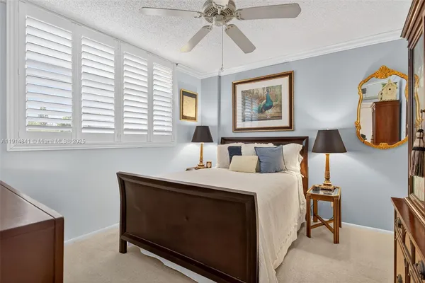 a bedroom with a bed and a lamp on table