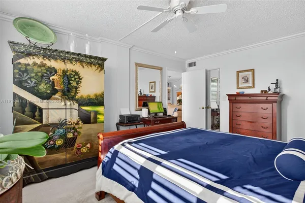 a living room with furniture and painting on the wall