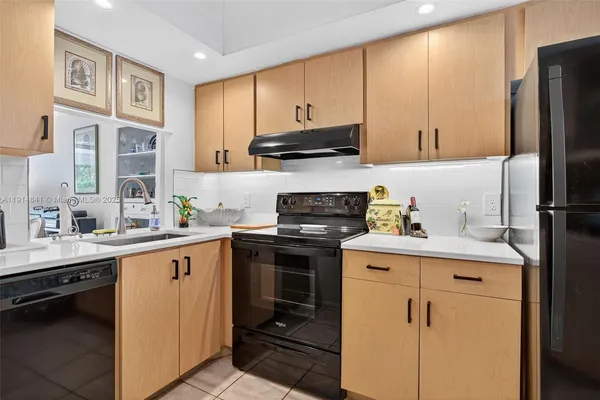a kitchen with a refrigerator and a stove