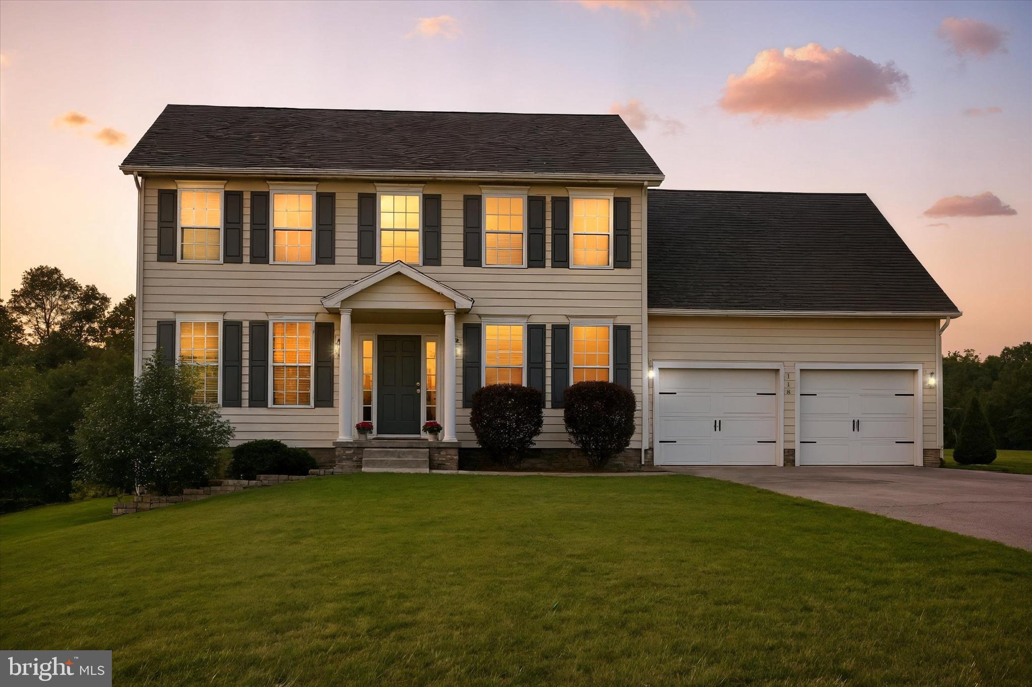 a front view of house with yard and green space