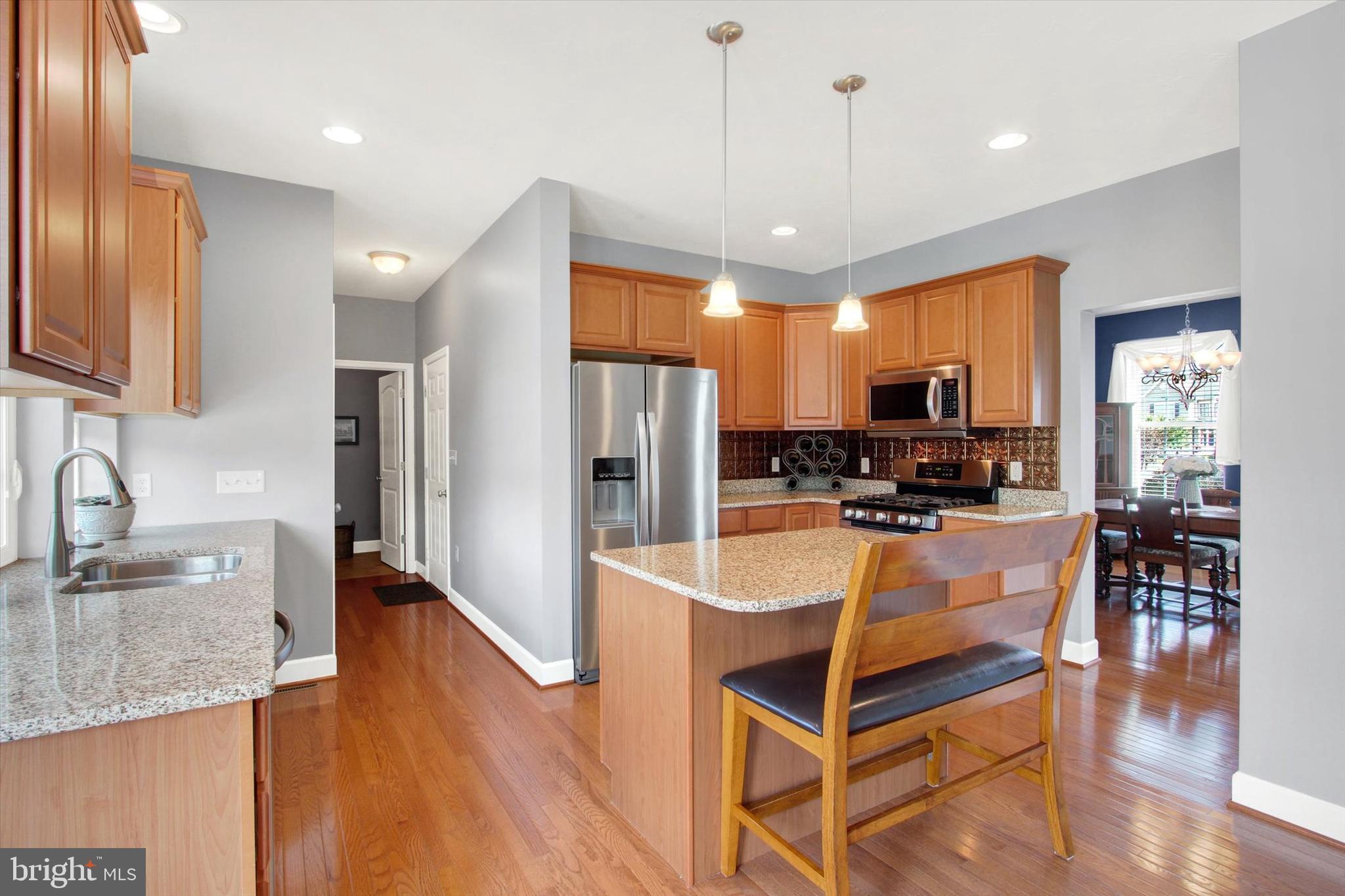 118 Fairplay Road Gettysburg, PA 17325 - Photo 11 of 43 a kitchen with stainless steel appliances granite countertop a refrigerator a sink a stove and a wooden cabinets