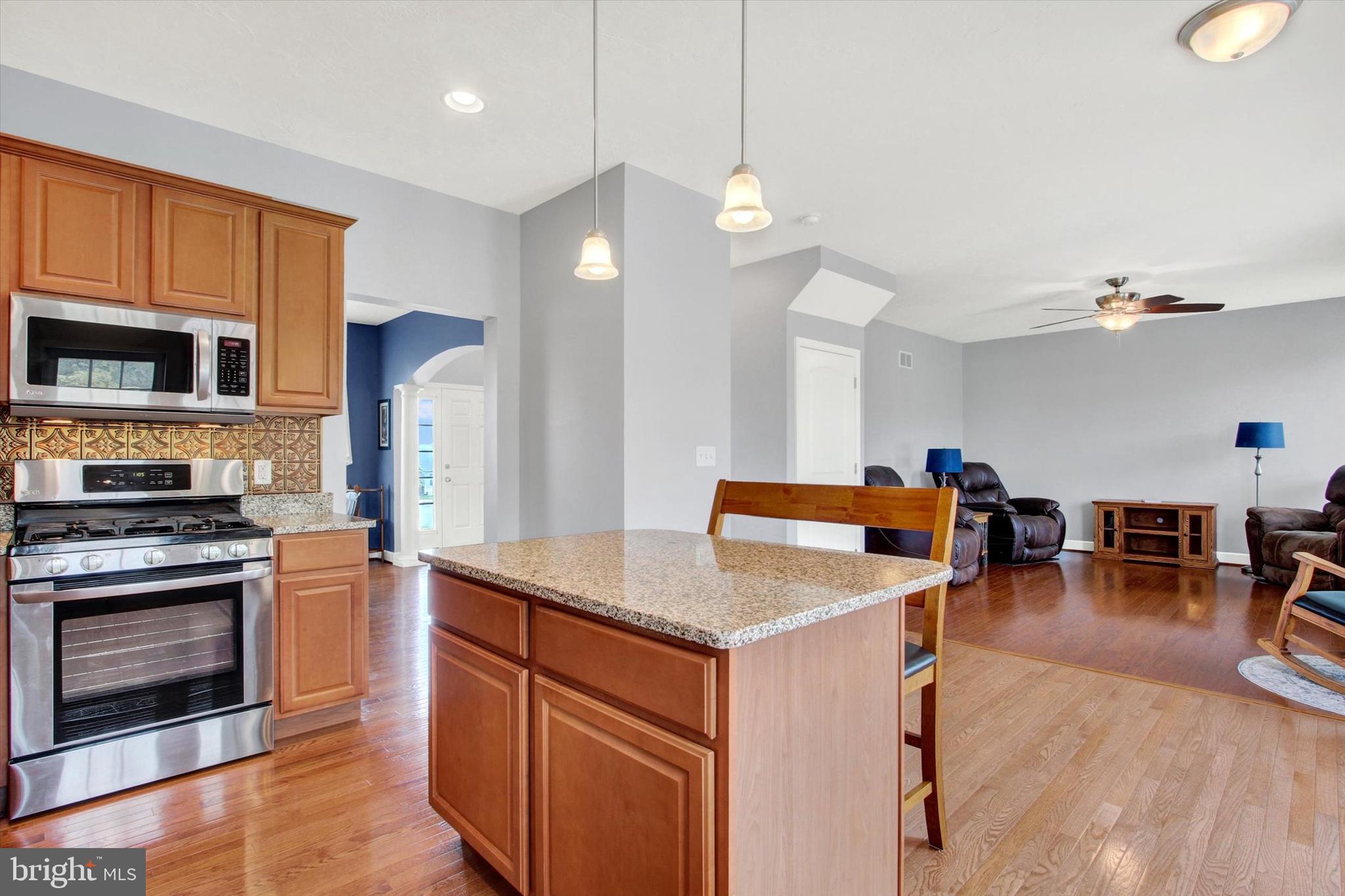 118 Fairplay Road Gettysburg, PA 17325 - Photo 12 of 43 a kitchen with stainless steel appliances granite countertop a stove and a wooden floors