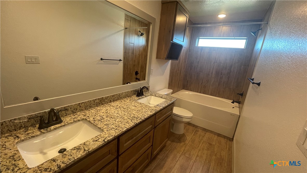 2408 Duntov Drive Temple, TX 76504 - Photo 11 of 41 a bathroom with a granite countertop sink and a mirror