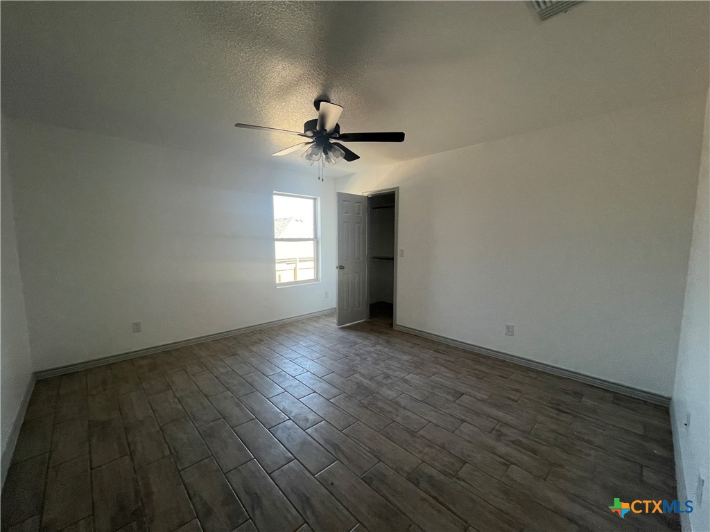 2408 Duntov Drive Temple, TX 76504 - Photo 18 of 41 an empty room with wooden floor and windows