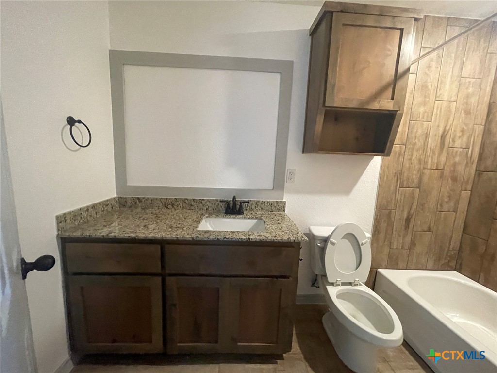 2408 Duntov Drive Temple, TX 76504 - Photo 36 of 41 a bathroom with a granite countertop toilet sink and mirror