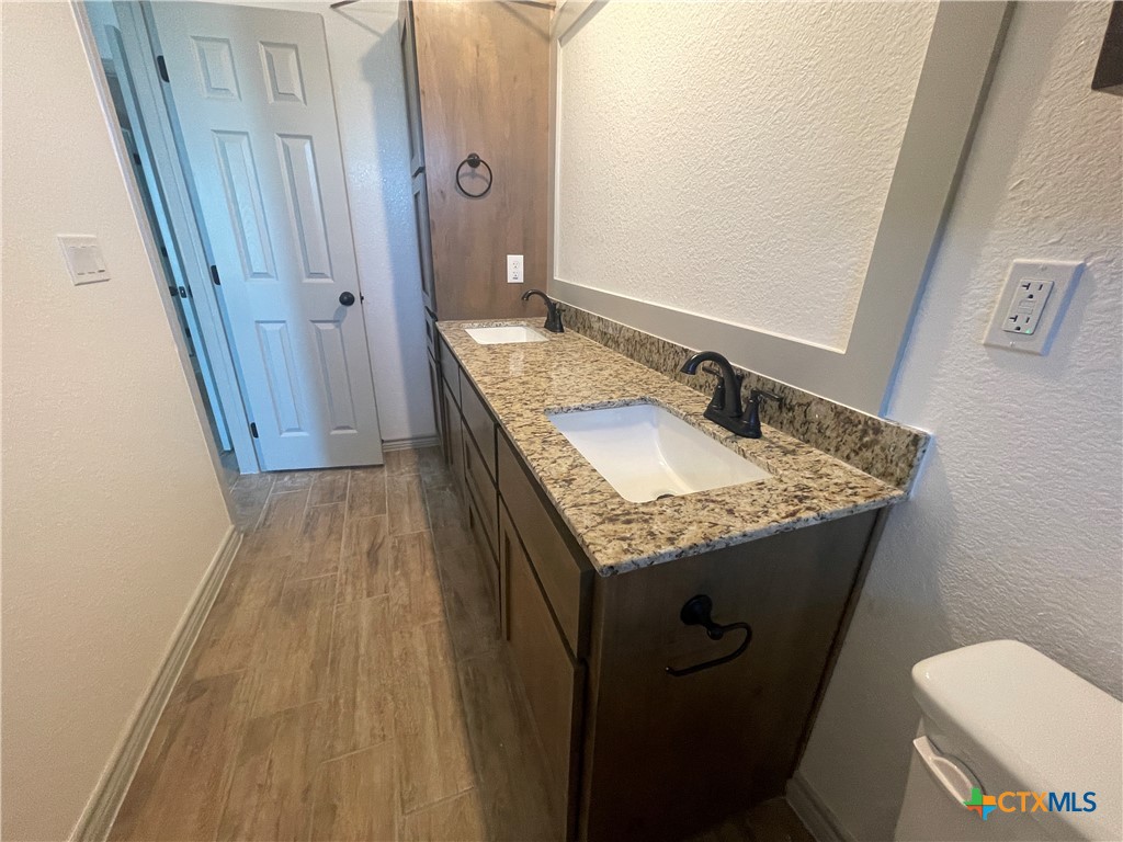 2408 Duntov Drive Temple, TX 76504 - Photo 38 of 41 a bathroom with a granite countertop sink and a mirror