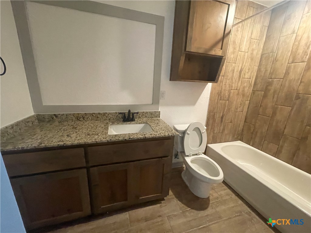 2408 Duntov Drive Temple, TX 76504 - Photo 39 of 41 a bathroom with a granite countertop sink and a mirror