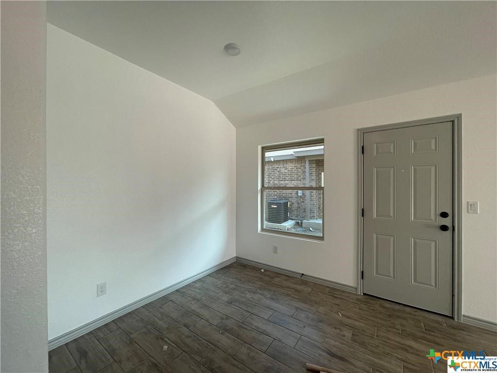 2408 Duntov Drive Temple, TX 76504 - Photo 4 of 41 an empty room with wooden floor and windows