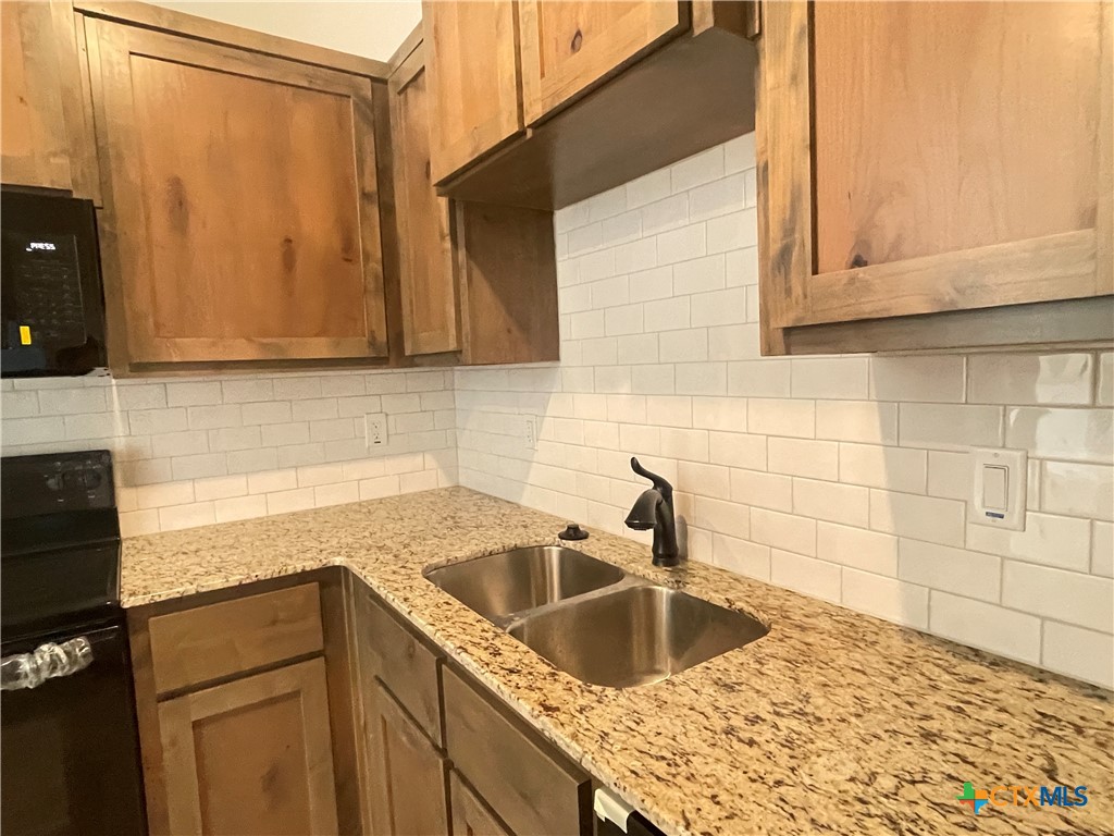 2408 Duntov Drive Temple, TX 76504 - Photo 9 of 41 a kitchen with a sink cabinets and a wooden floor