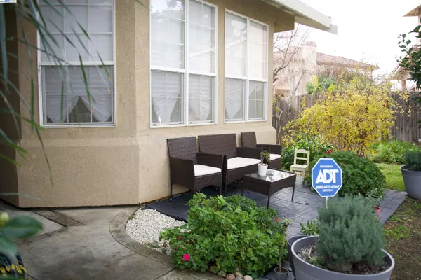 a front view of a house with a yard and outdoor seating