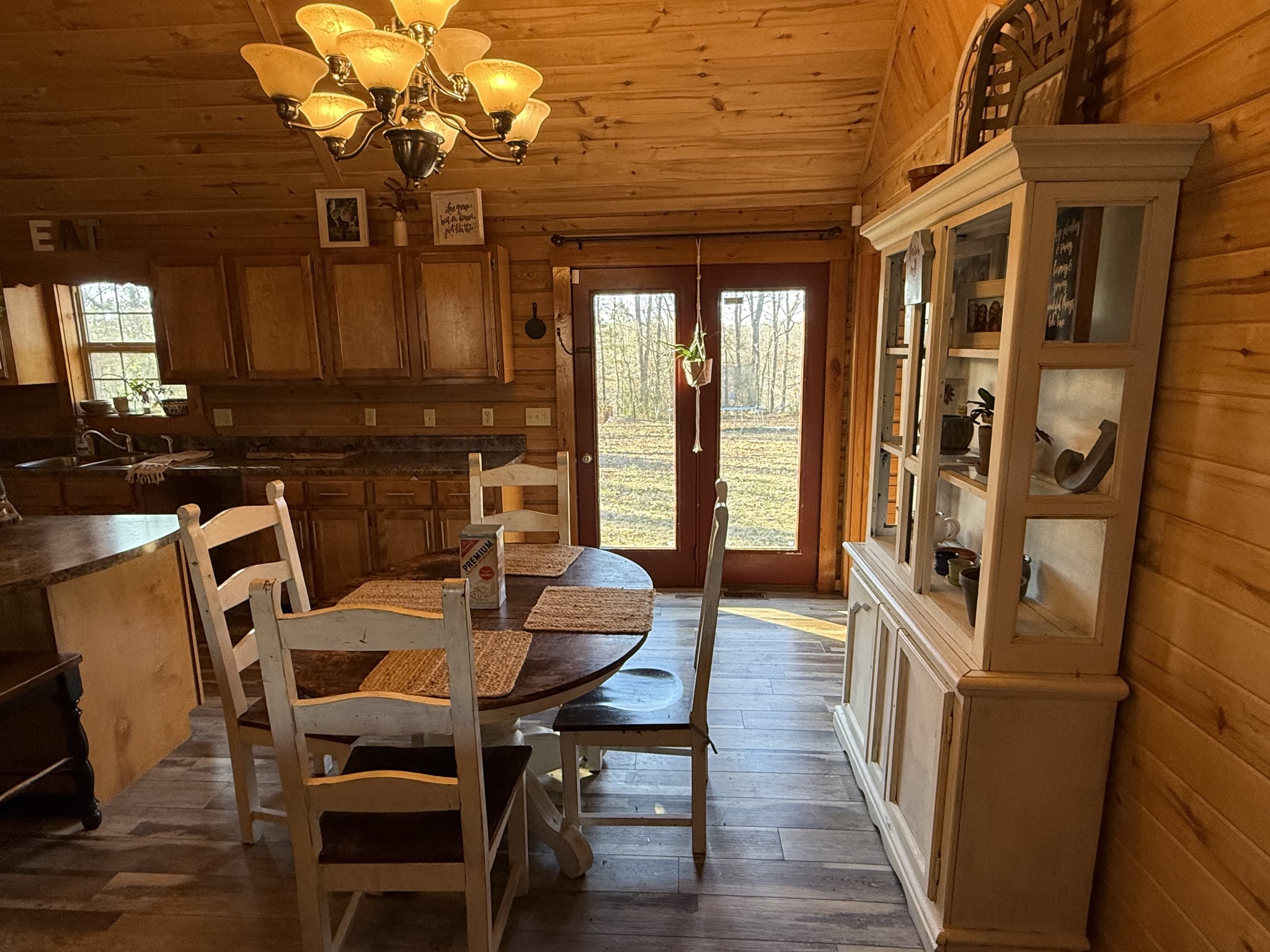 6843 Rabbit Creek Road Buchanan, TN 38222 - Photo 16 of 61 a view of a dining room with furniture a chandelier and wooden floor