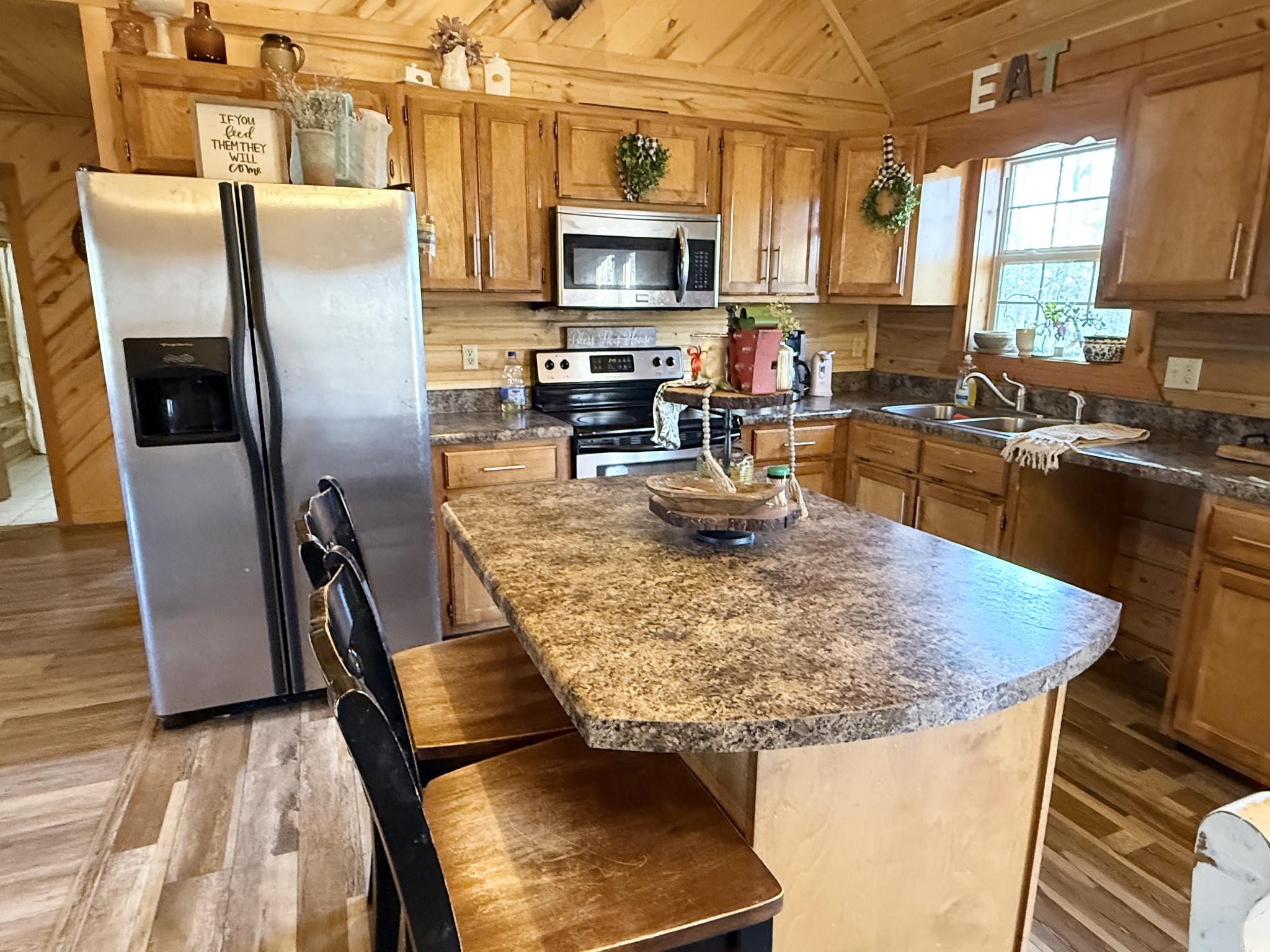 6843 Rabbit Creek Road Buchanan, TN 38222 - Photo 19 of 61 a kitchen with stainless steel appliances granite countertop a stove top oven a sink a dining table and chairs