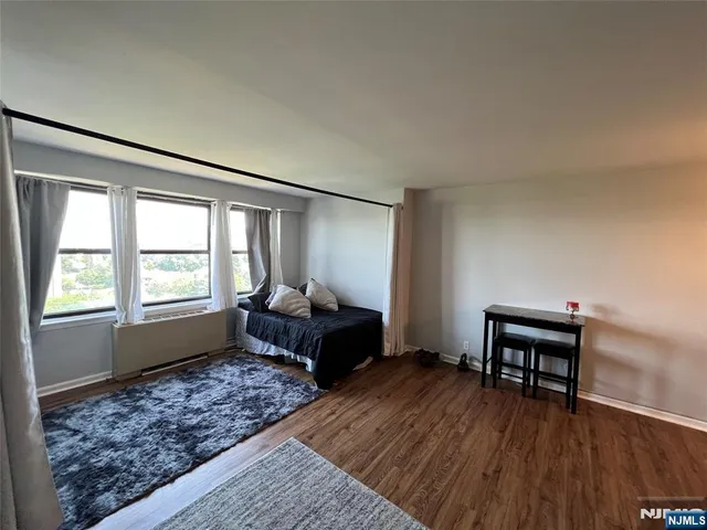 a bedroom with furniture and a window